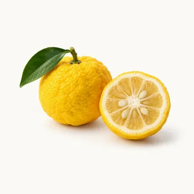 Owoc yuzu z liściem i połówka yuzu - nuta yuzu w ginie